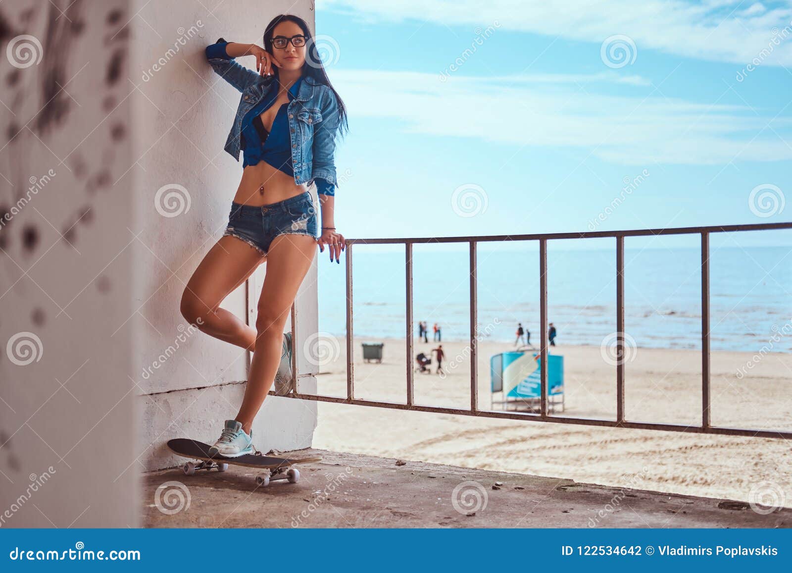 https://thumbs.dreamstime.com/z/sexy-brunette-girl-wearing-shorts-jeans-jacket-standing-skateboard-leaning-guardrail-against-sea-coast-short-122534642.jpg