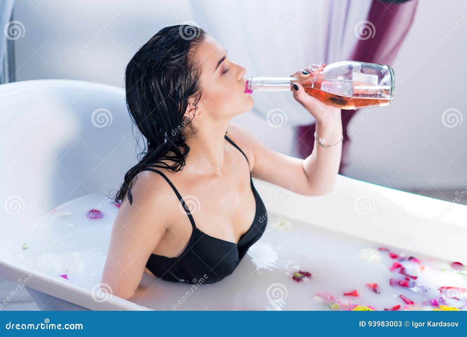Brunette Woman Drinking Champagne while Taking Hot Bath Stock Image image