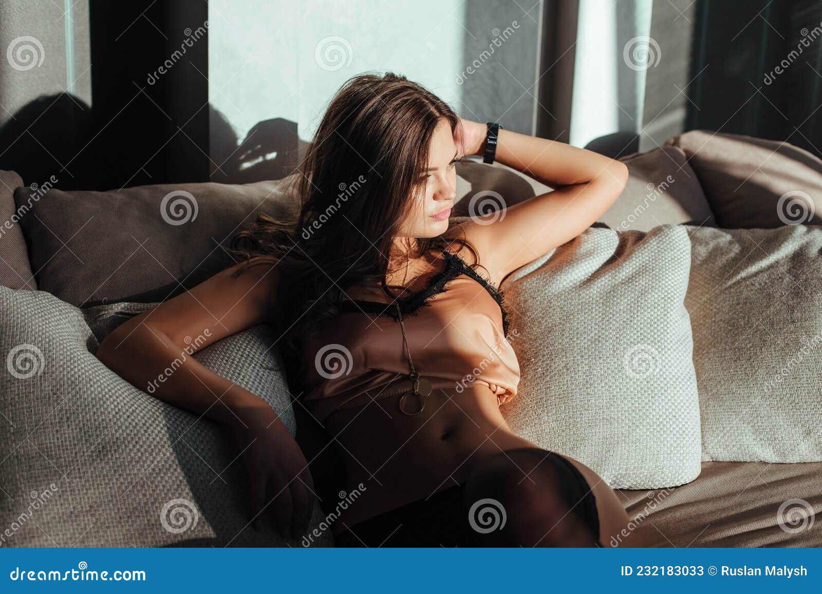 Brunette Woman Posing in Elegant Lingerie, Looking at Camera