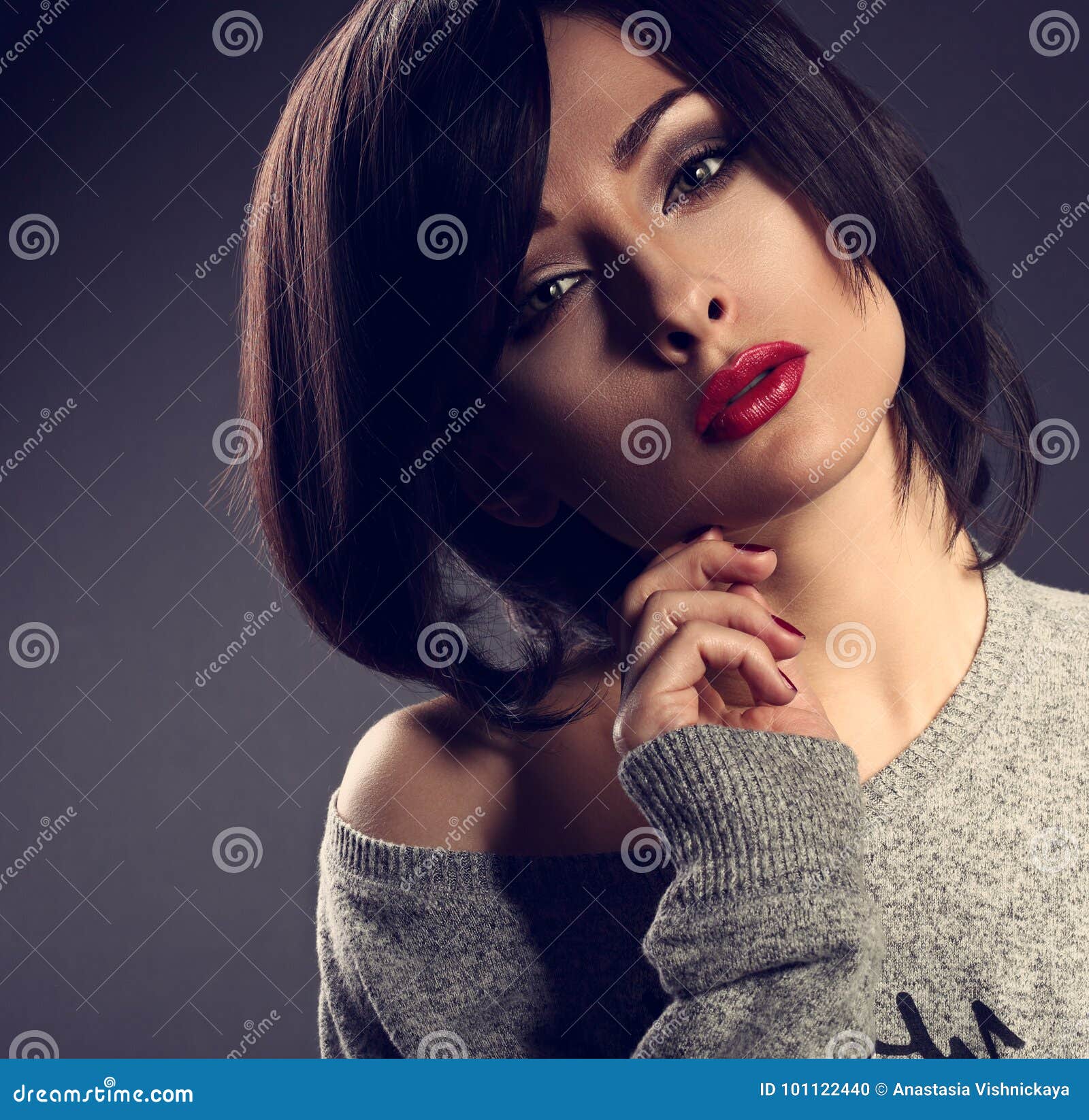 cocky emotion makeup woman with short bob hair style, red l