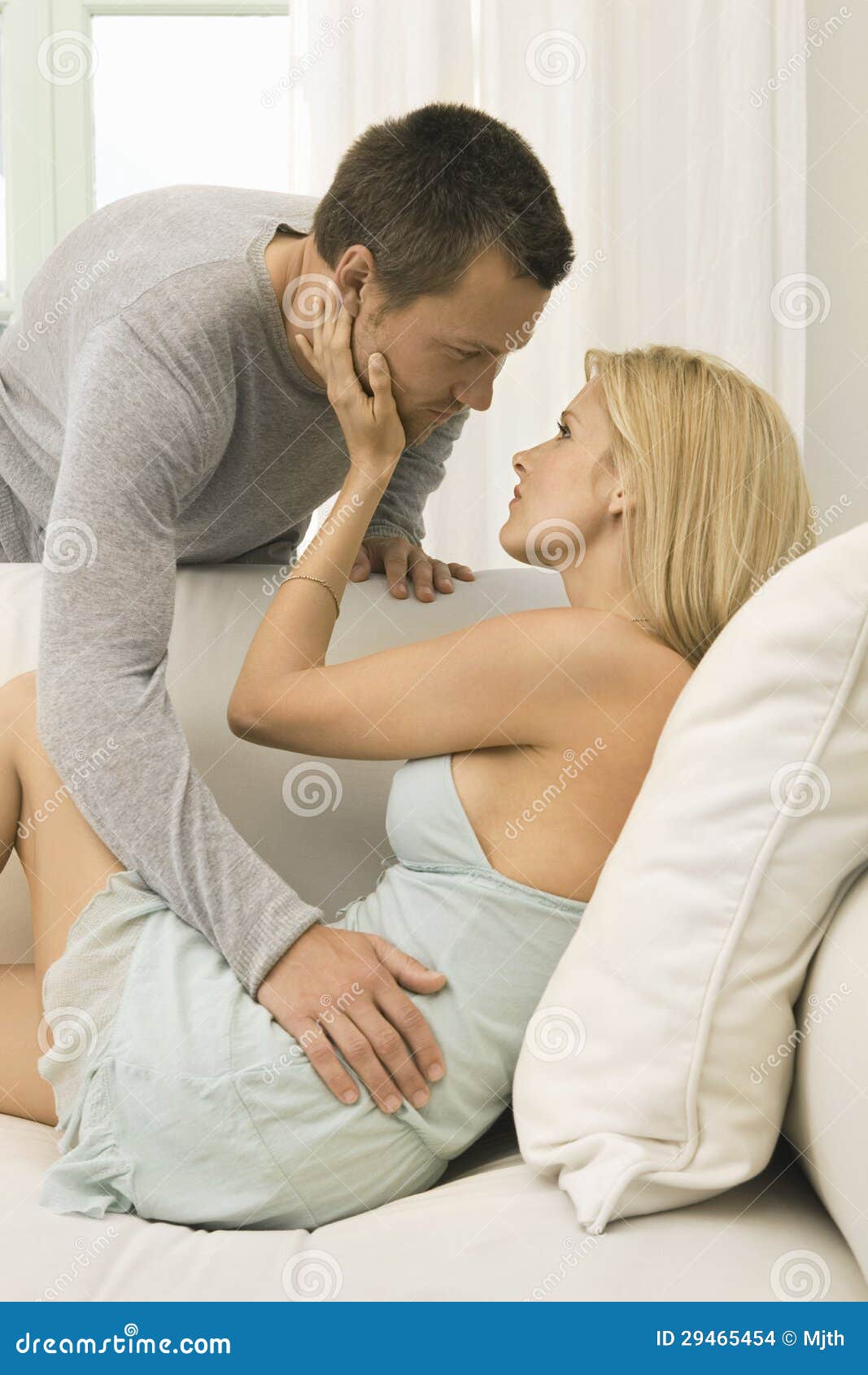 Couple On Sofa At Home Stock Photo