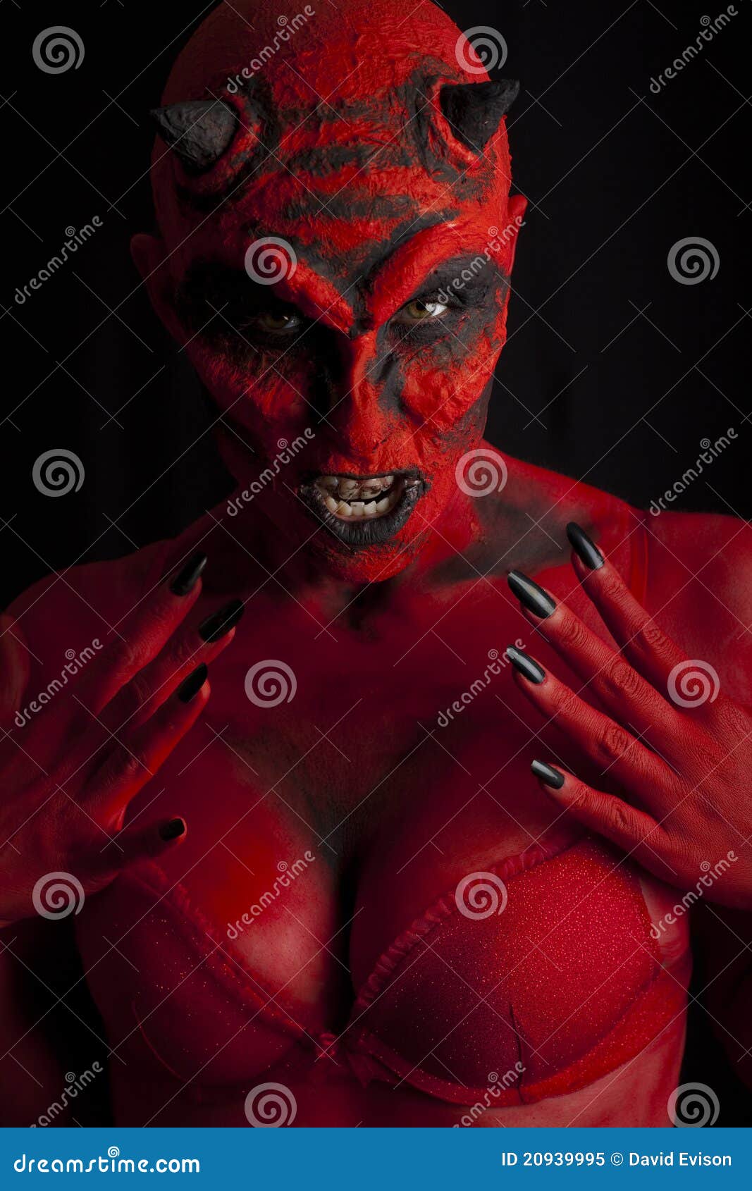 Photo about Red devil woman, low key lighting. 