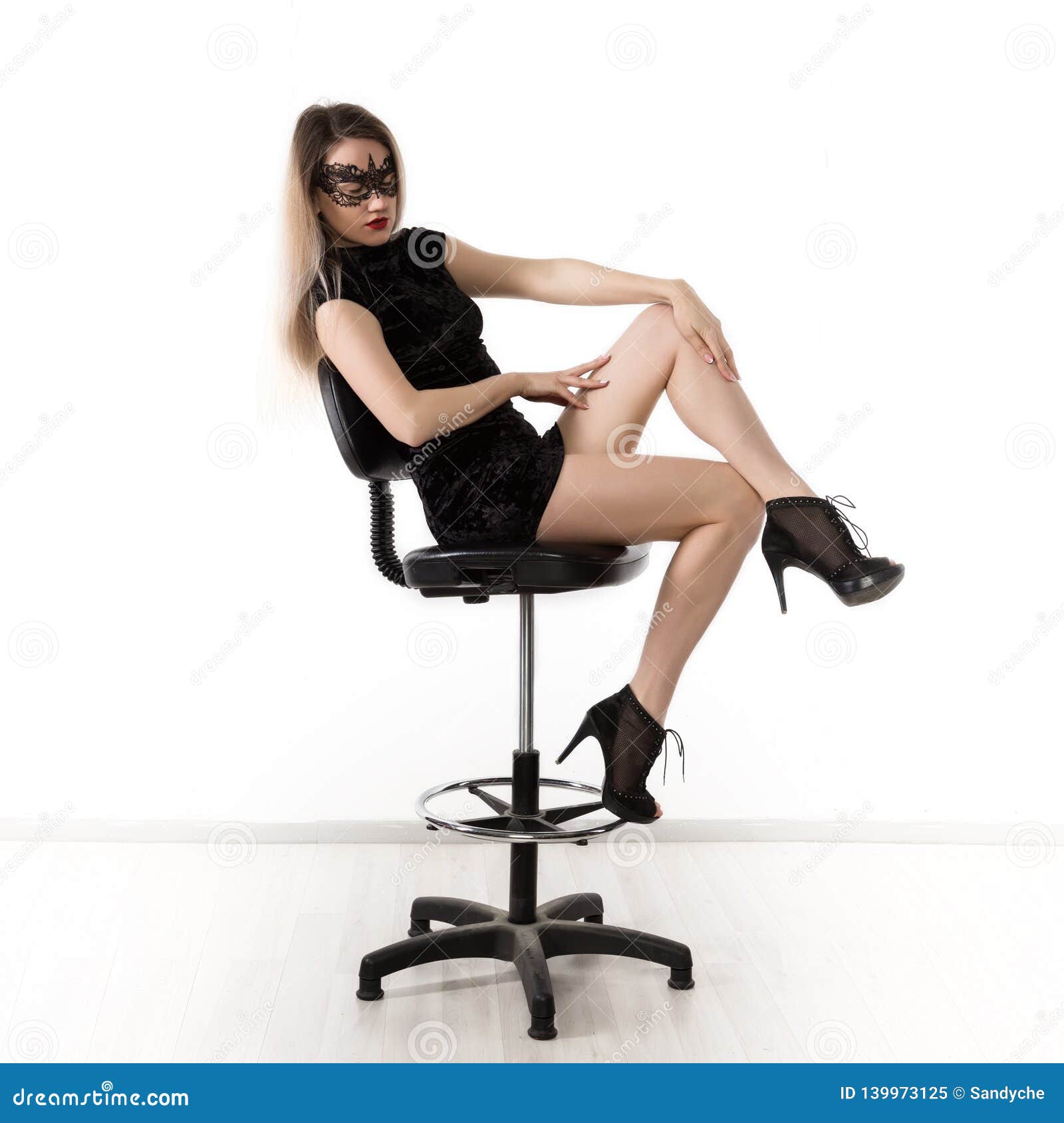 Elegant Womanin a Little Black Dress is Posing while Sitting on a High  Chair and Spreading Her Legs. Girl on a Stock Image - Image of bandeau,  confident: 139973125