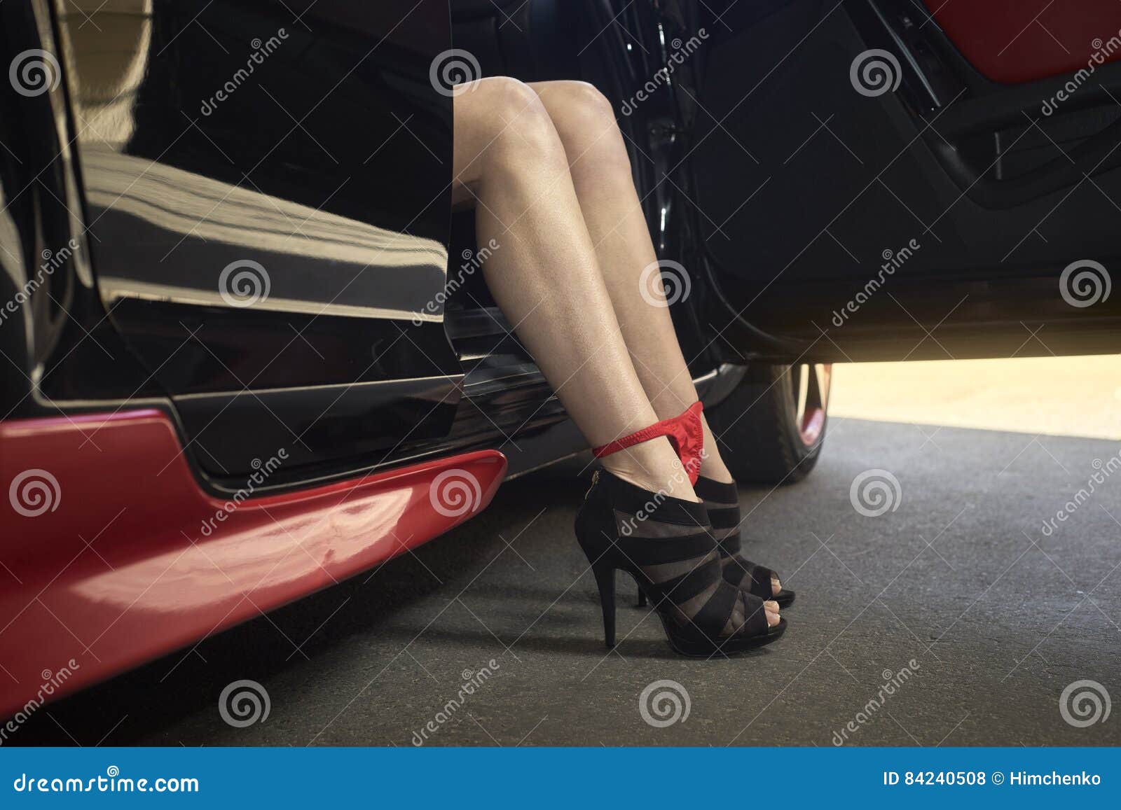 Female legs in a car stock photo. Image of female, light 84240508