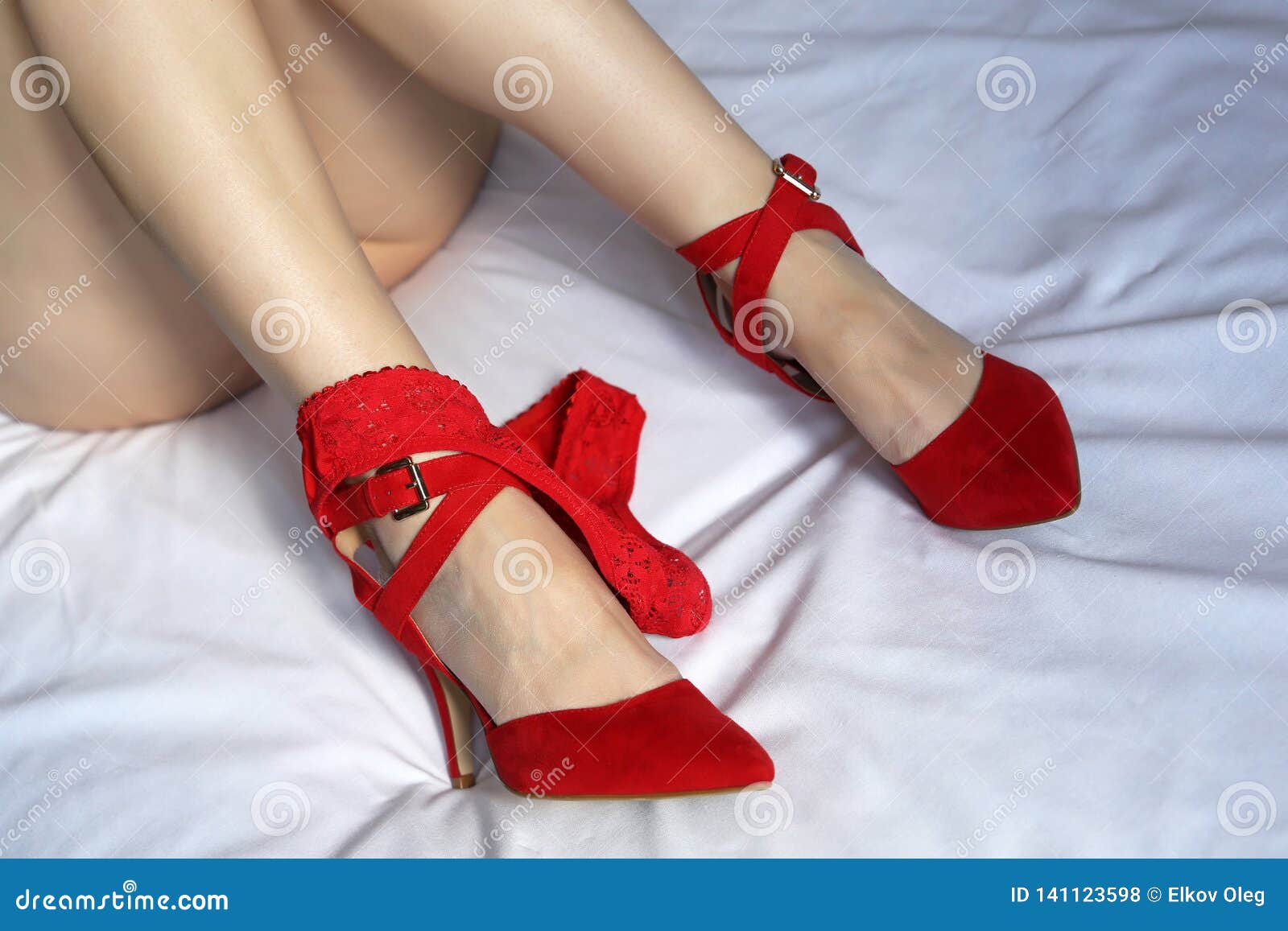 Naked Girl Lies on the Bed with Red Panties Down Stock Photo