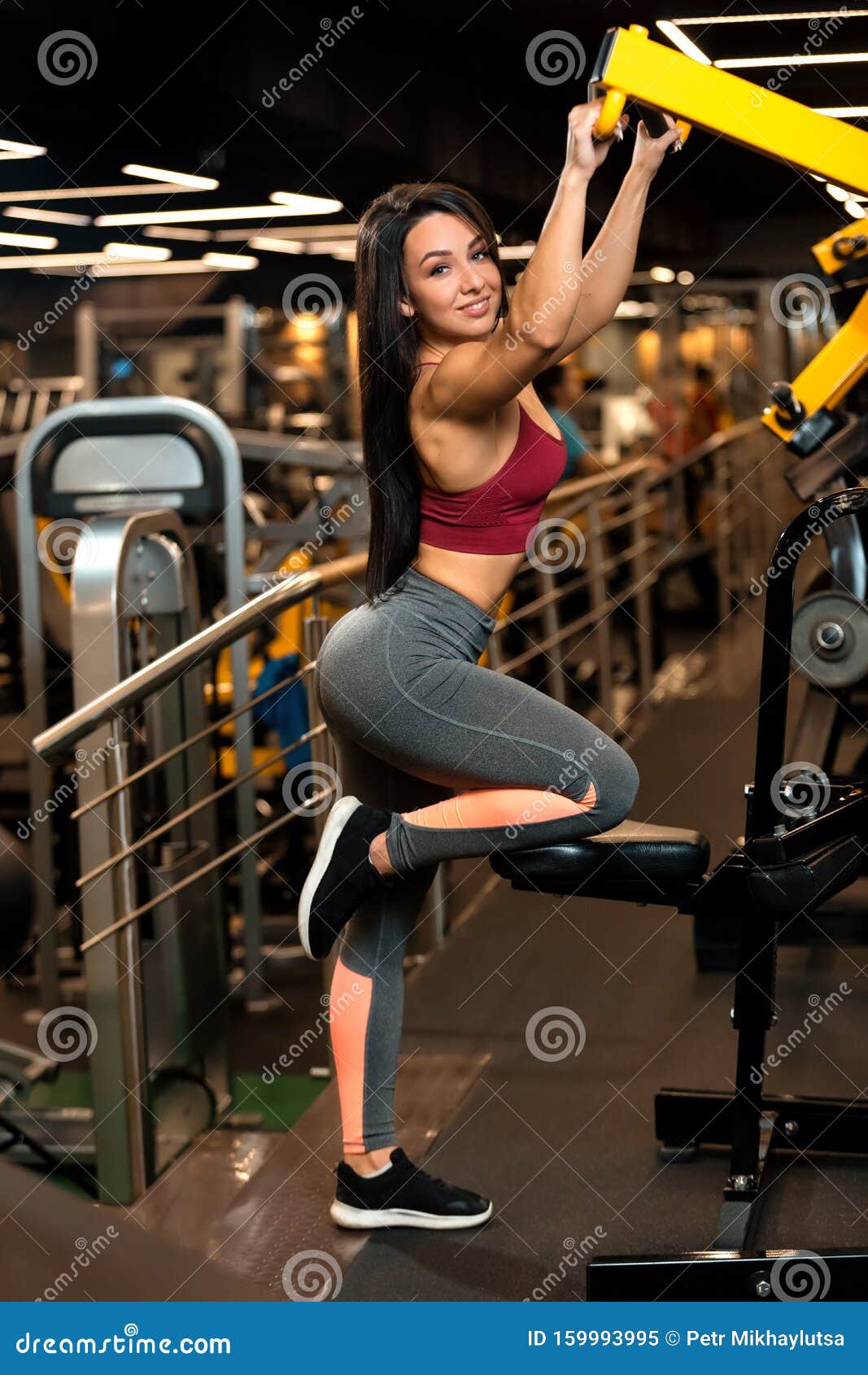 Fitness Brunette Girl is Sitting and Doing Shoulder Exercises in Trainer  Stock Image - Image of shape, beautiful: 159993995