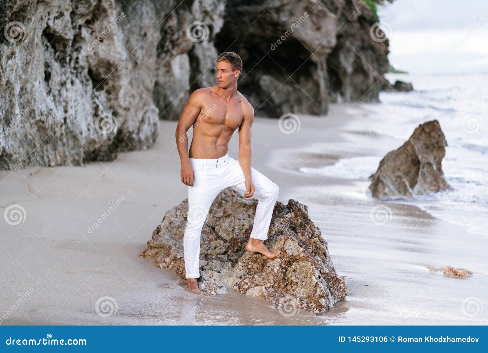Fitness Male Model in White Pants and Shirtless Posing on Tropical Sandy  Beach Stock Photo - Image of person, muscular: 145293106