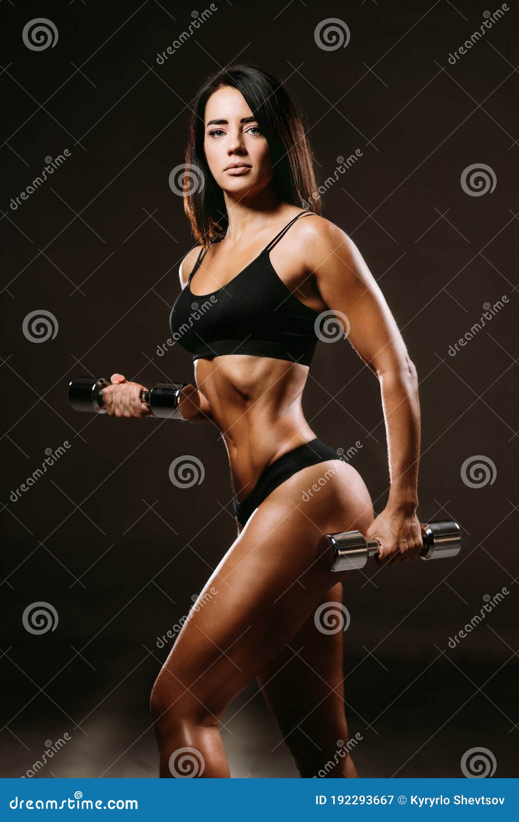 sexy fitness woman posing in underwear with dumbbells
