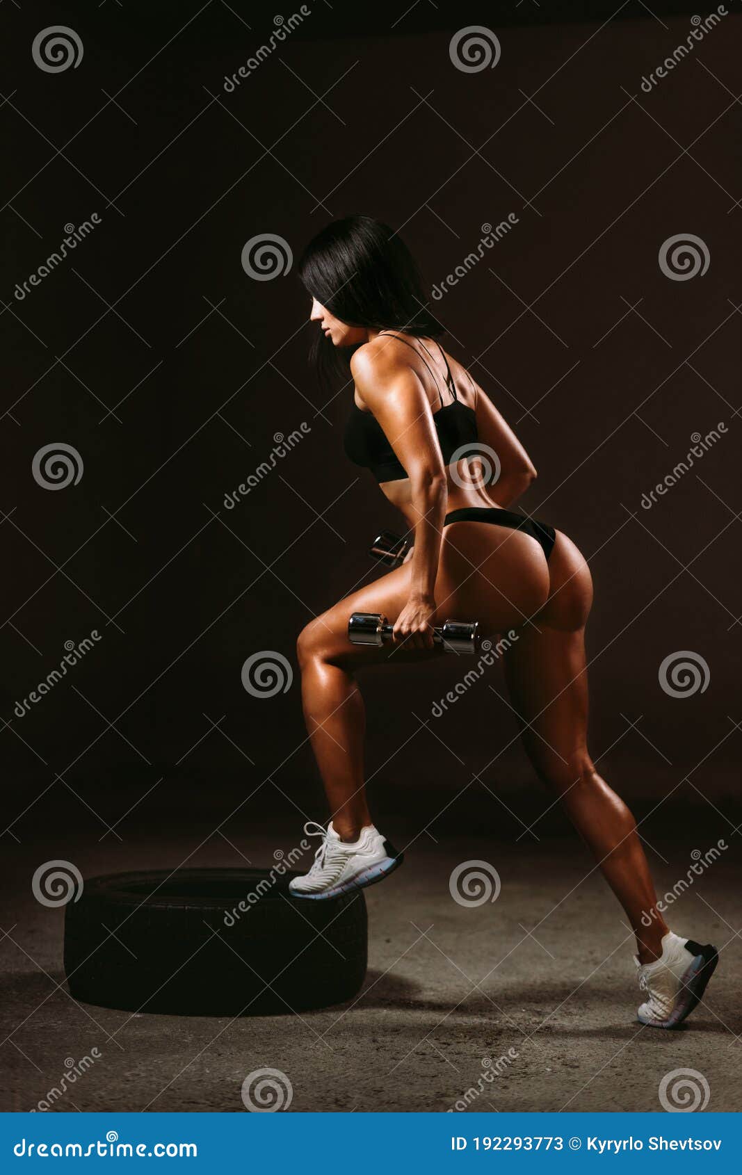 sexy fitness woman posing in underwear with dumbbells