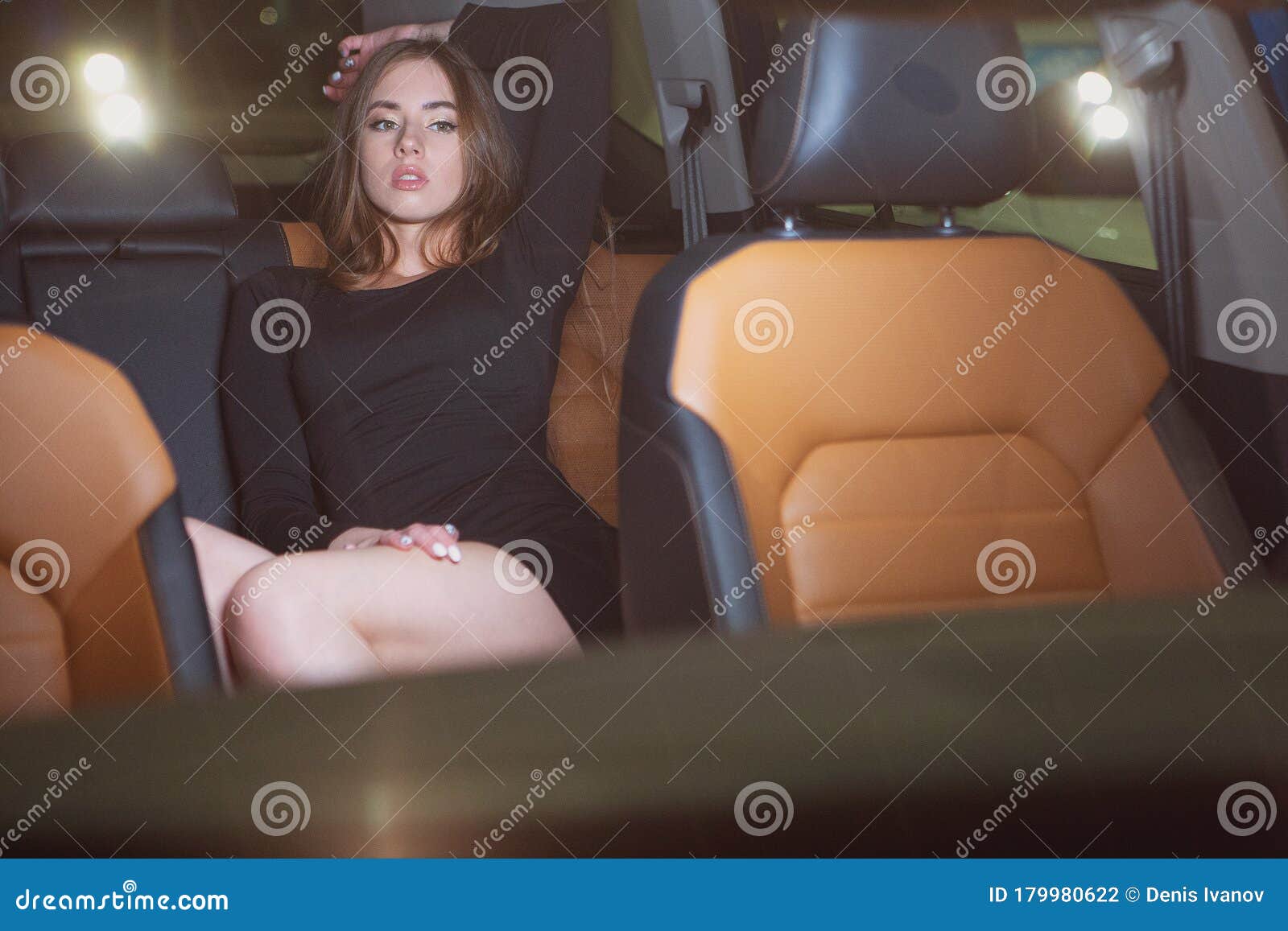 sexy girl in the back seat of a prestigious car