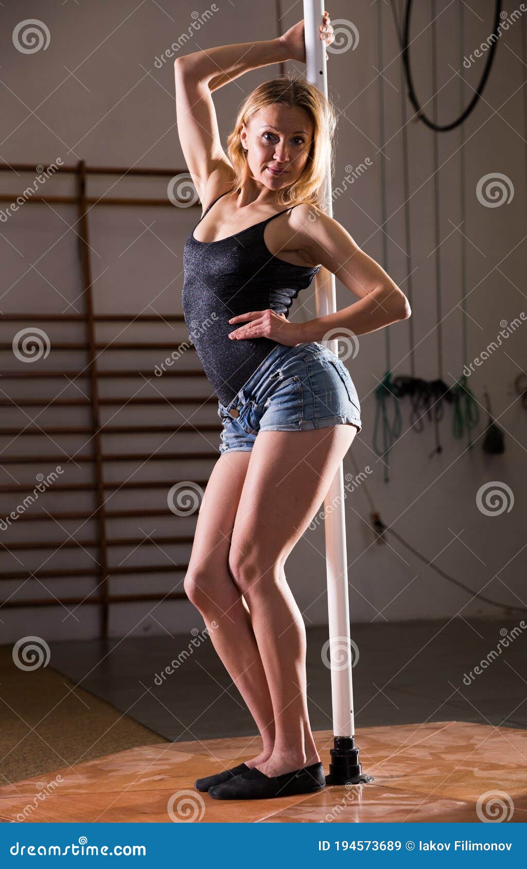 Young Woman In Denim Shorts Practicing Pole Dancing Stock Photo, Picture  and Royalty Free Image. Image 128252944.