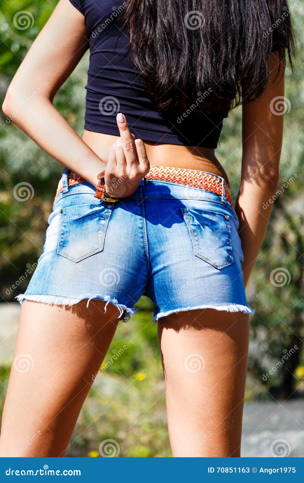 Girl in Jeans Shorts Show Middle Finger Up pic