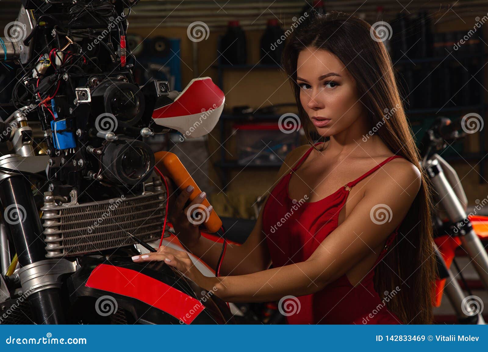 girl repairing motorcycle