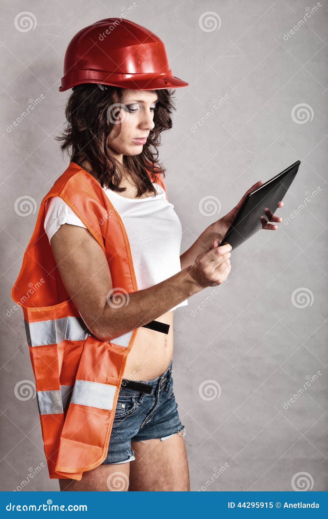 Girl In Safety Helmet Using Tablet Touchpad Stock Image