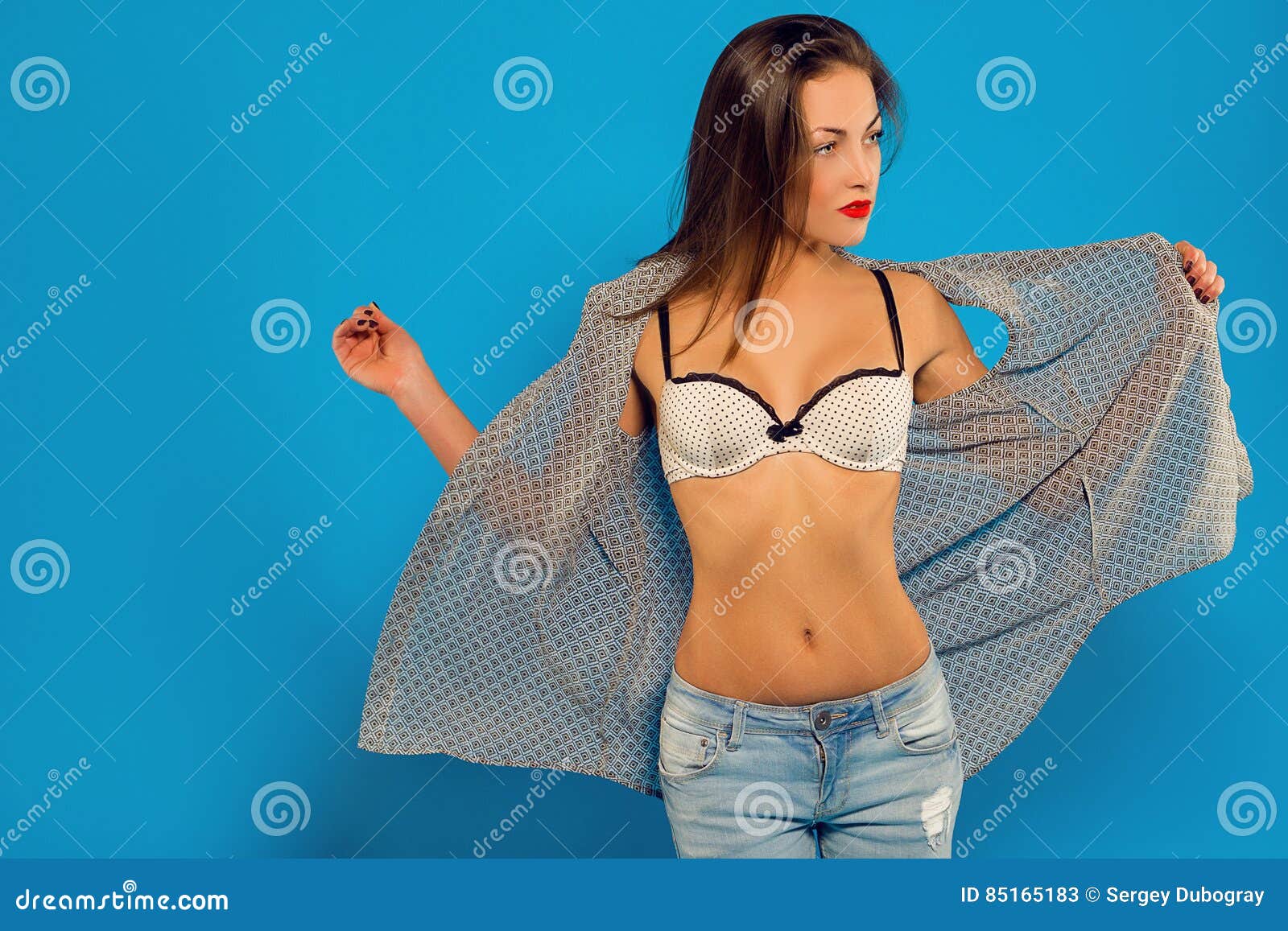 https://thumbs.dreamstime.com/z/sexy-girl-takes-off-his-shirt-showing-bra-blue-background-85165183.jpg