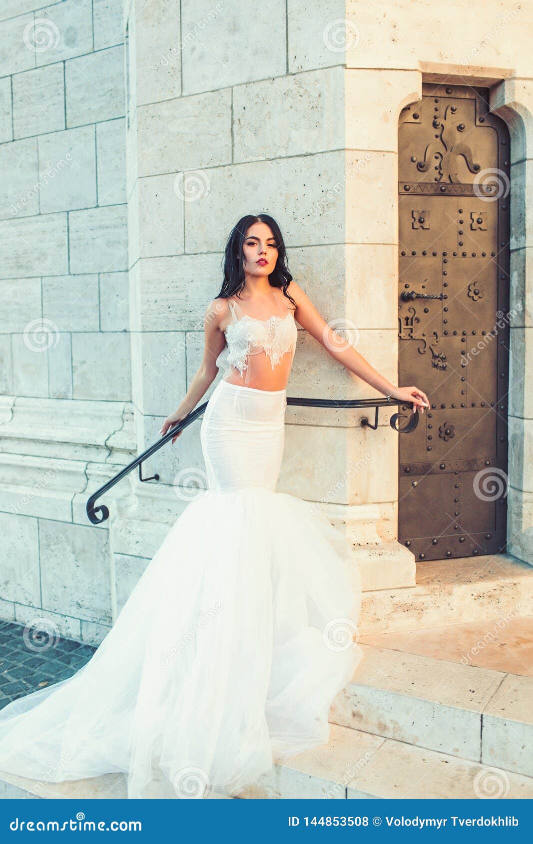 Girl in White Dress with Stylish Hair. Bride Girl at Wedding