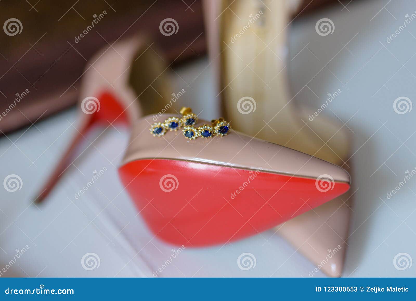 White Shoes With A Red Sole On The Foot Of The Bed, Close-up Stock Photo,  Picture and Royalty Free Image. Image 126064281.