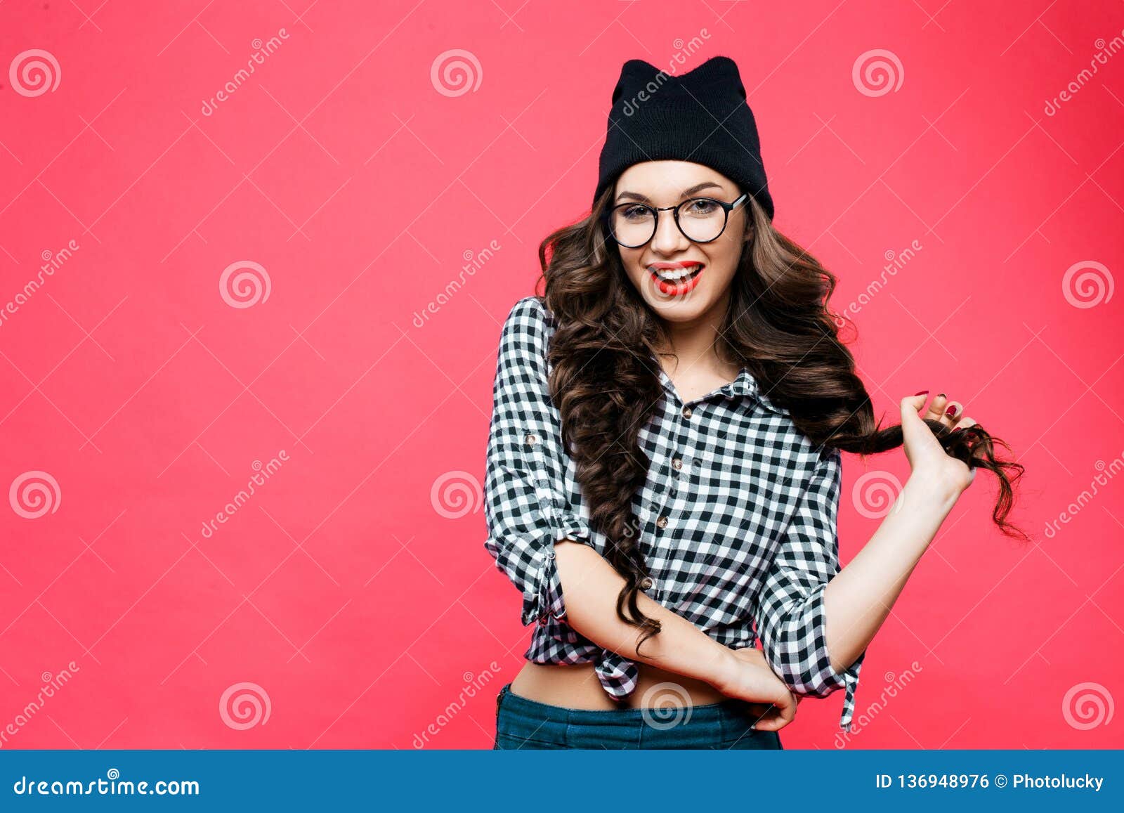 Attractive Young Woman In Glasses And Knitted Cap. Red Lipstick