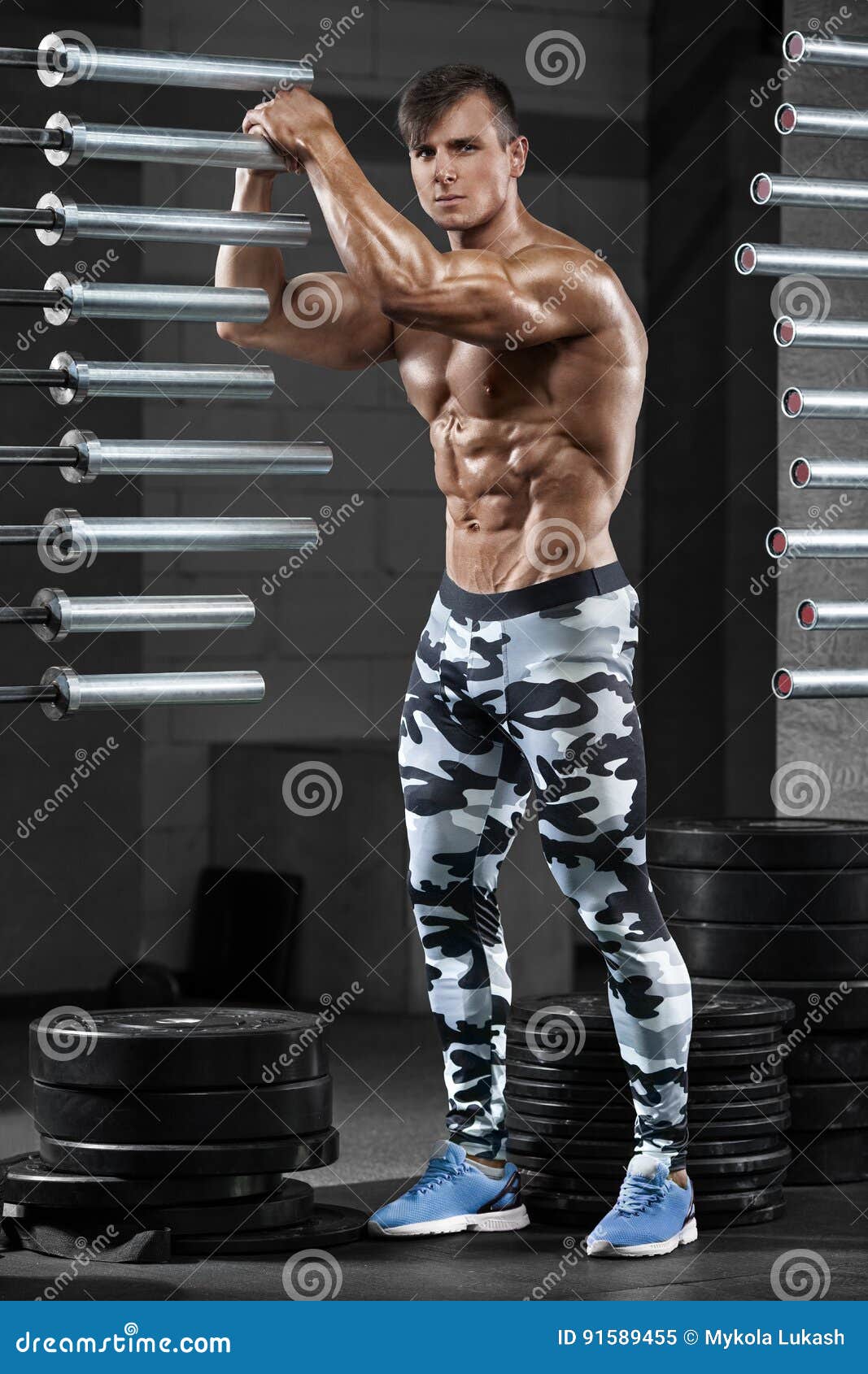 Muscular Man Showing Muscles, Posing In Gym. Strong Male 
