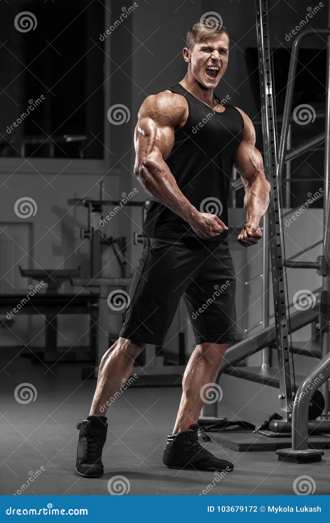 Handsome Muscular Man Flexing Muscles In Gym Stock Photo 