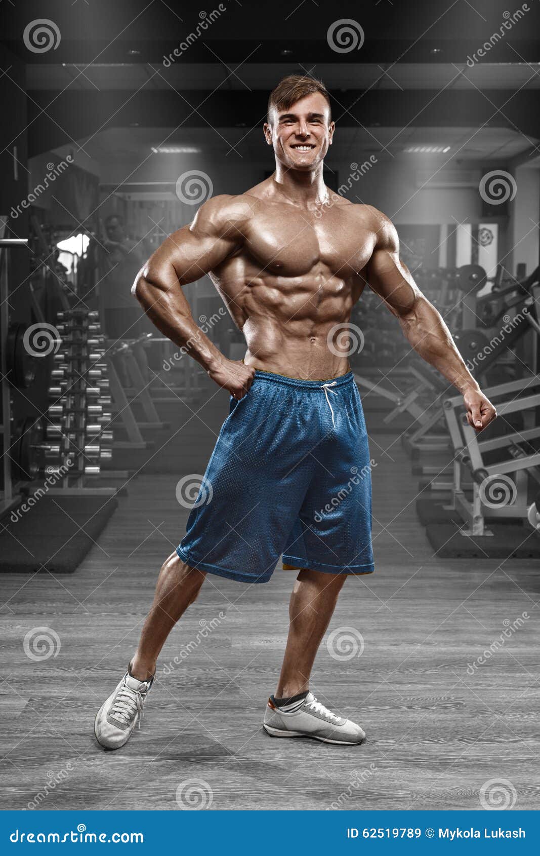 Muscular Man Working Out In Gym Doing Exercises On 