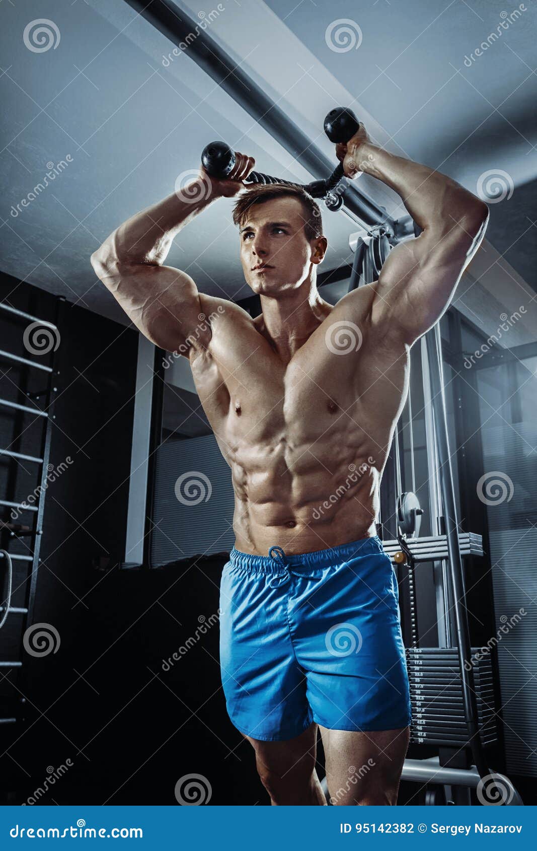 Sexy asian muscular man posing in gym, shaped abdominal 