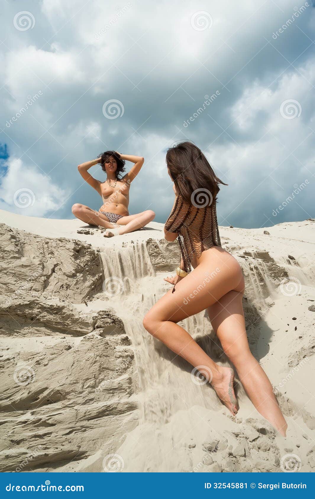 Appealing naked babes are relaxing on the beach