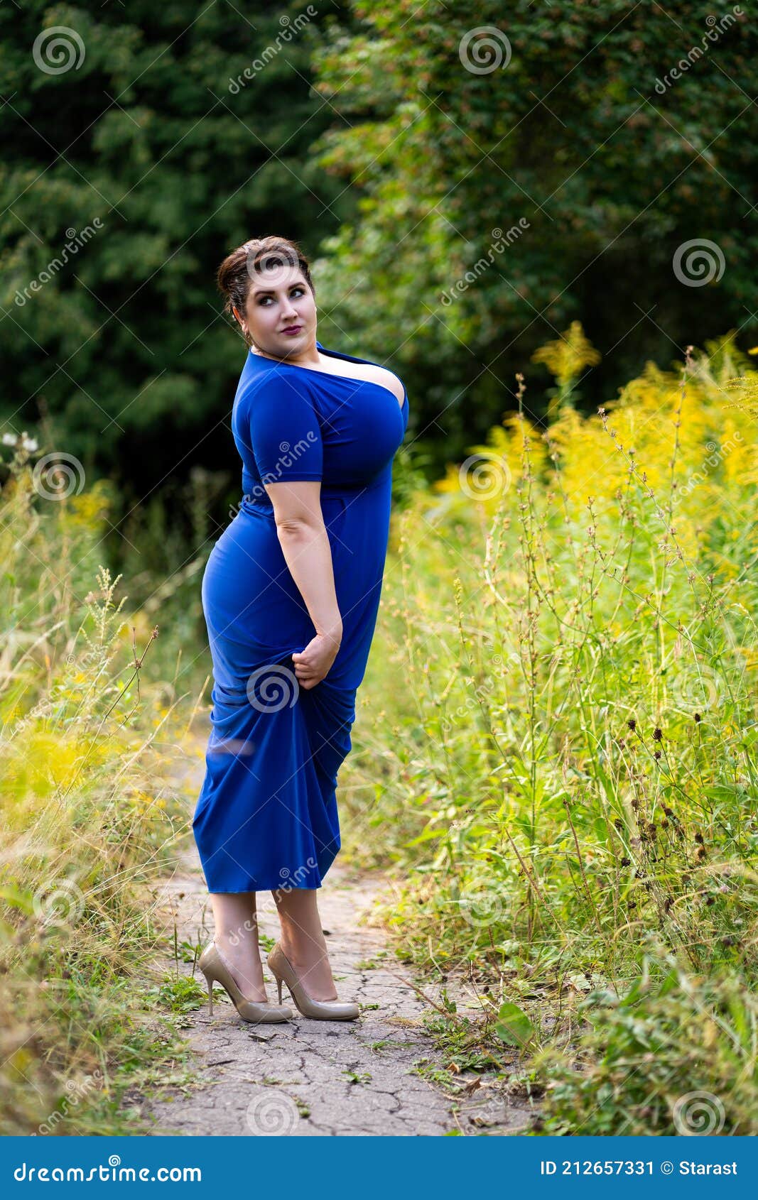 Plus Size Model in Blue Dress with a Deep Neckline Outdoors, Beautiful Fat  Woman with Big Breasts in Nature Stock Image - Image of beauty, loss:  212657321