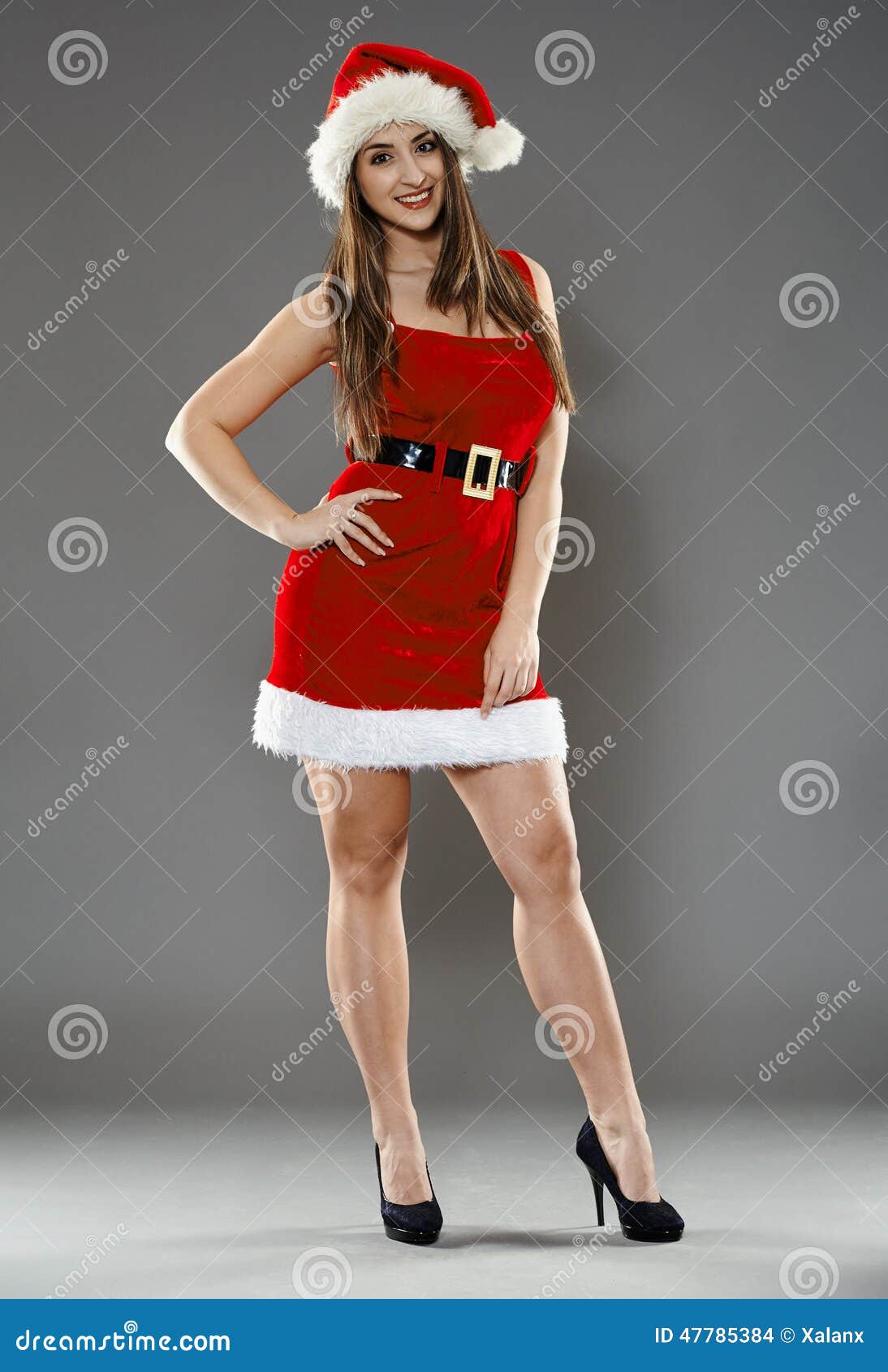 Santa helper. Full length of Santa girl on gray background