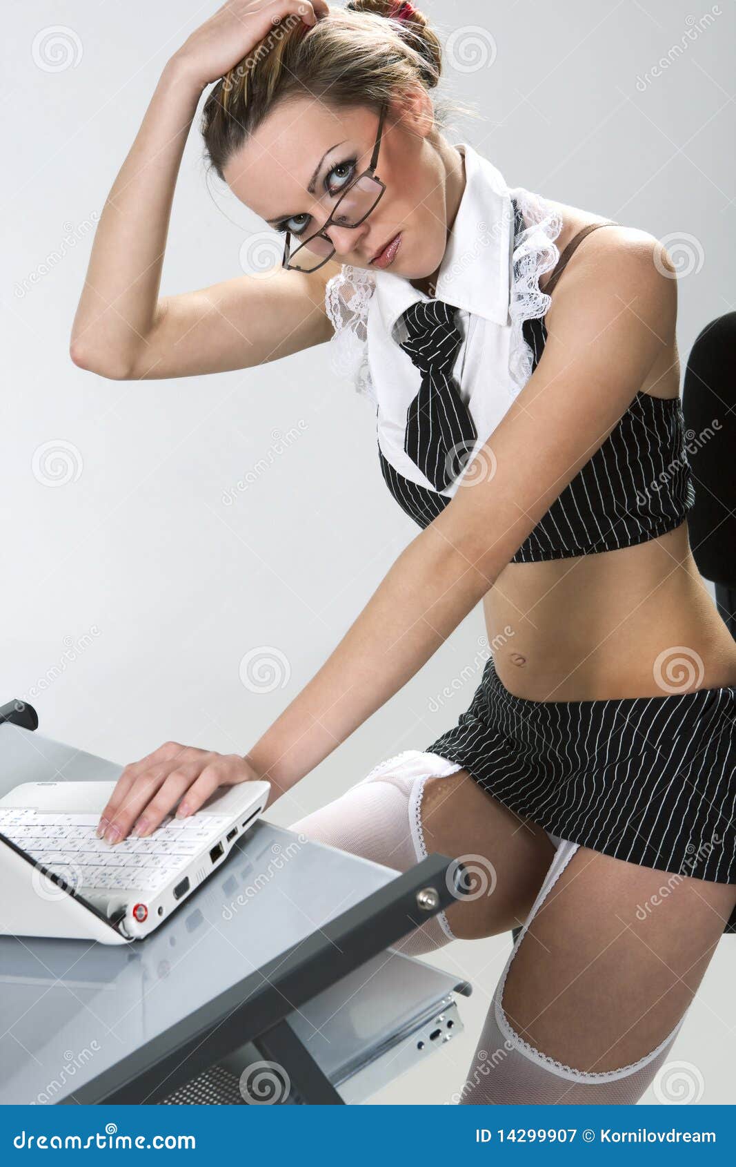 secretary laptop. Beautiful secretary wearing very short skirt pretending to work on laptop