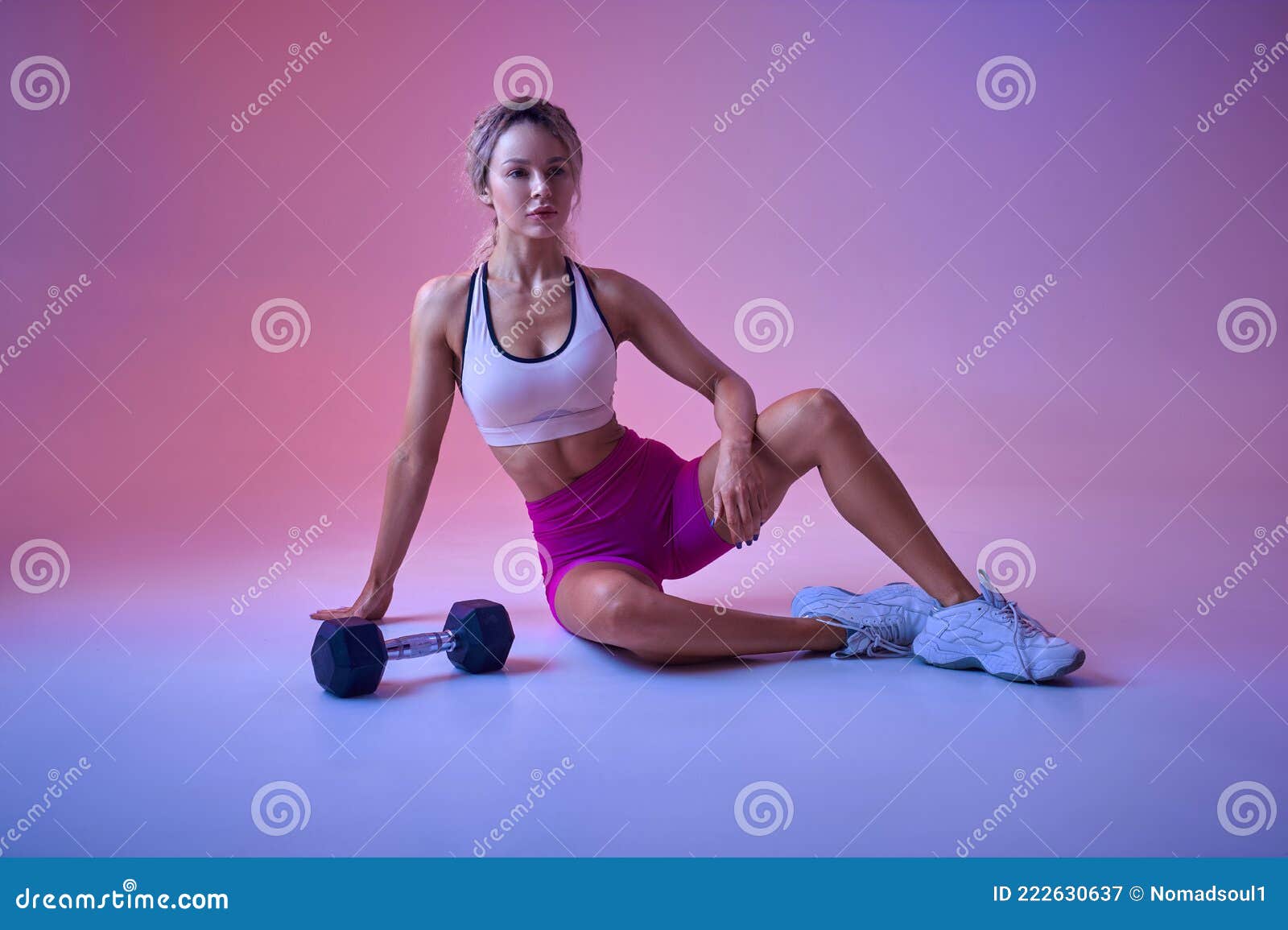 Fitness model posing with dumbbells Stock Photo - Alamy