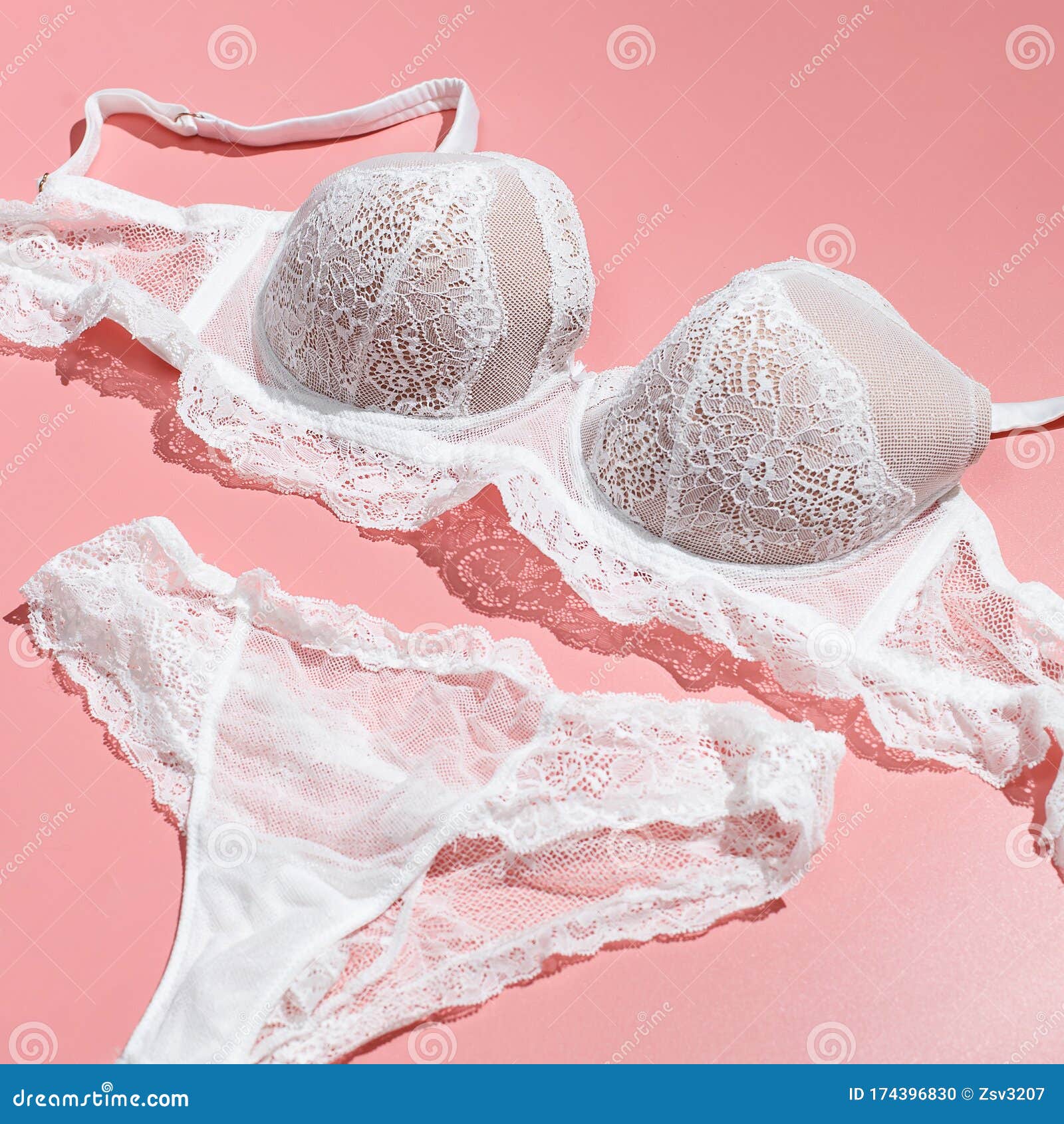 Sexy White Lace Bra And Panties On Pink Background. Stylish