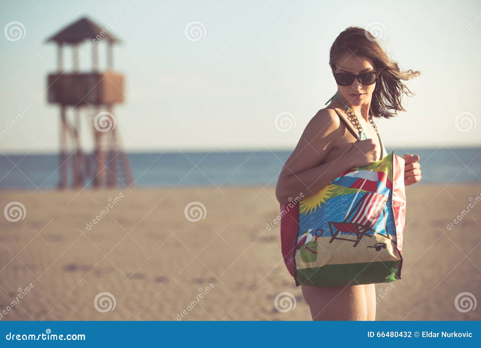 woman on beach vacation with accessories.beach accessory.going to the sandy beach vacation.summer beach fashion style