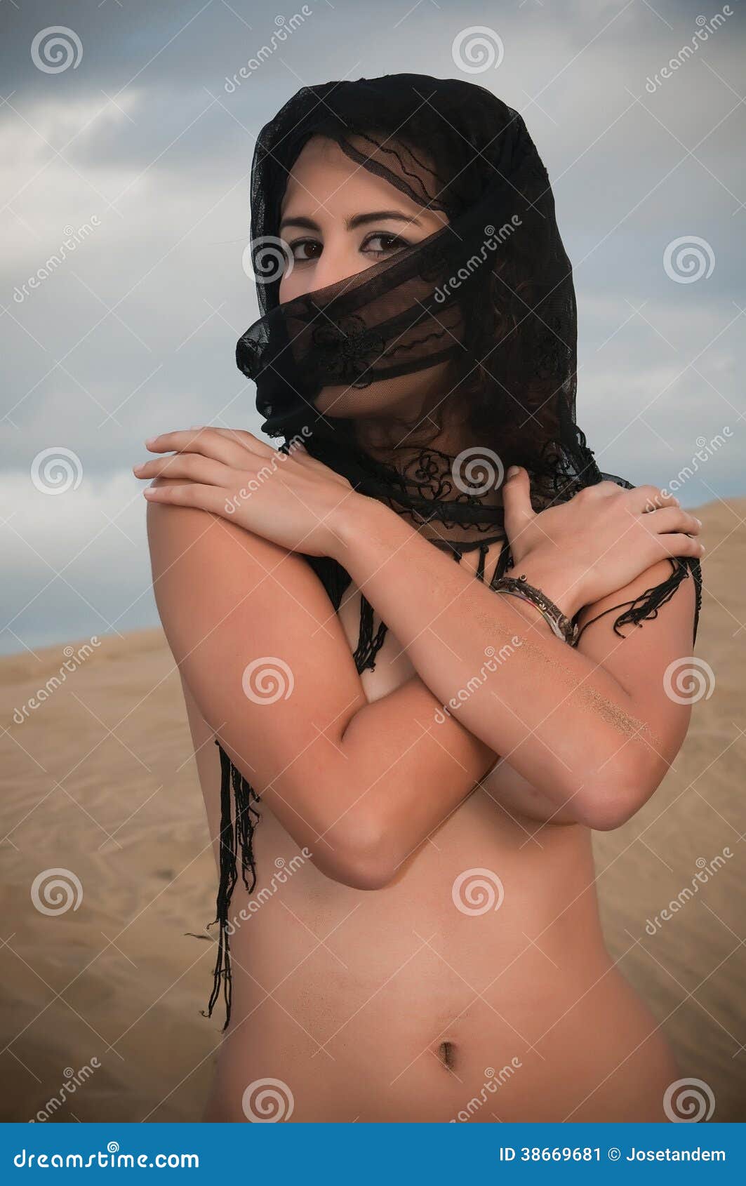 Woman Belly Dancer Arabian in Desert Dunes Stock Image