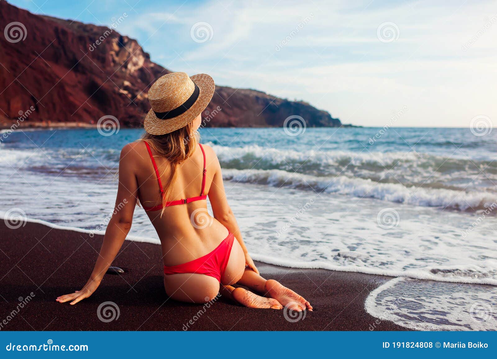 Woman In Bikini Relaxing On Red Beach In Santorini Greece Girl Sitting In Water Summer