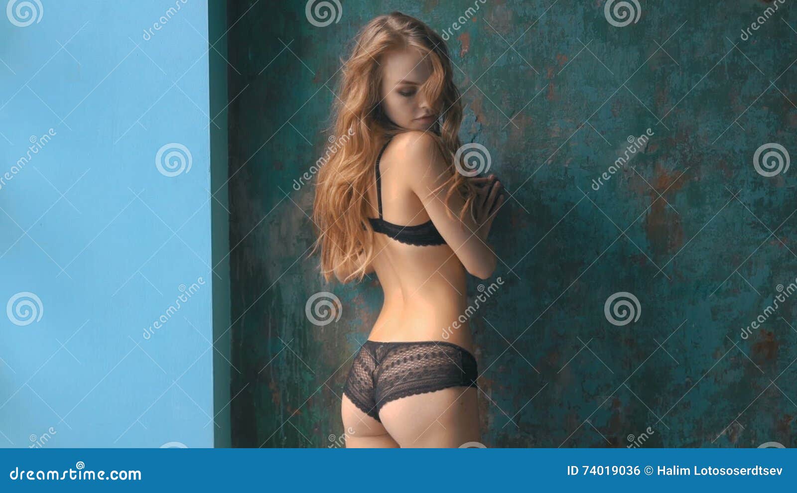 Woman in Black Lingerie Posing Near the Old Wall Stock Footage picture
