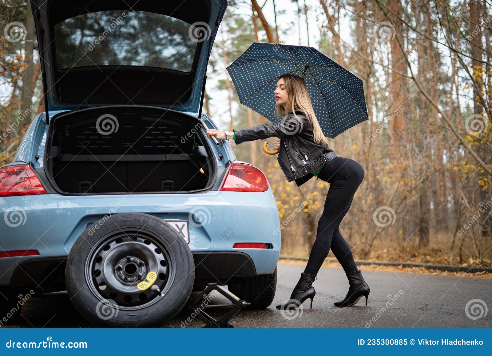 Woman on the Heels with Broken Car on the Empty Road Waits for Help pic