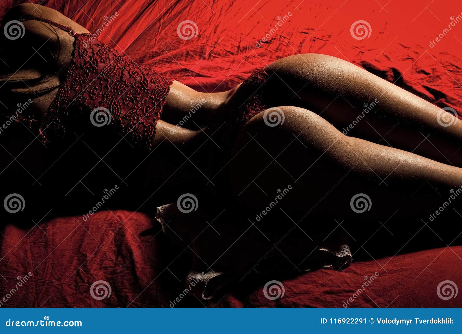 Attractive Slime Cute Girl On Bed In Red Panties Stock Photo
