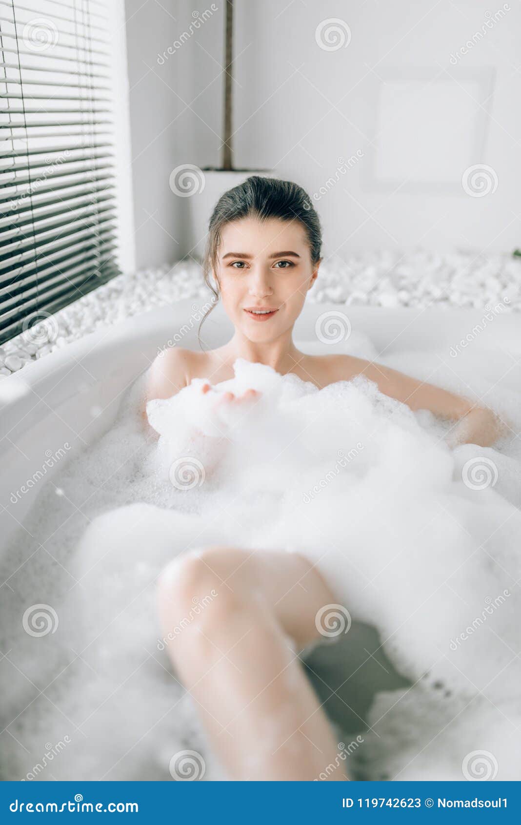 Attractive lady lying in bath with rose petals Stock Photo by NomadSoul1