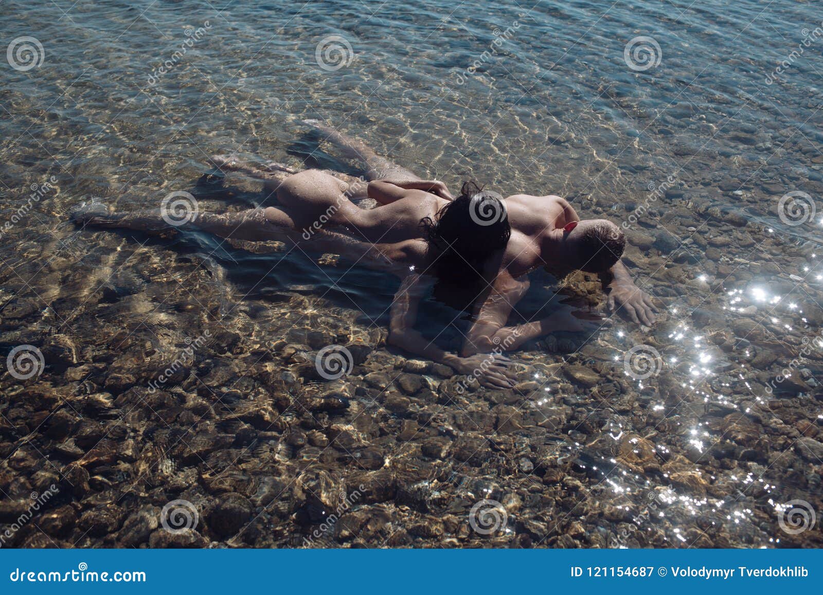 Woman and Man Have Sex Games. Couple in Love with Body Relax on Beach picture