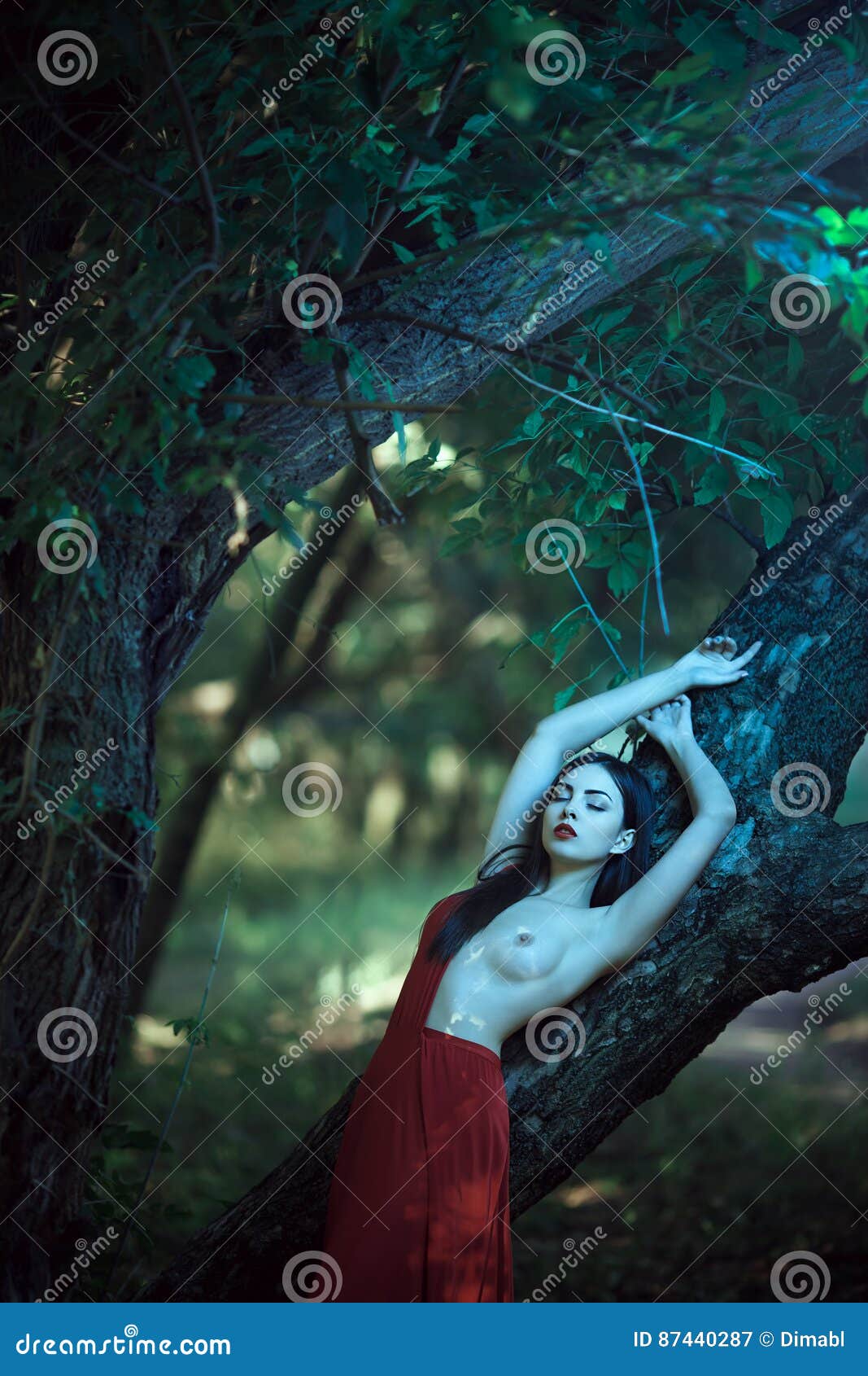 957px x 1300px - Woman With Naked Breast In Red Dress In Fairy Forest. Stock ...