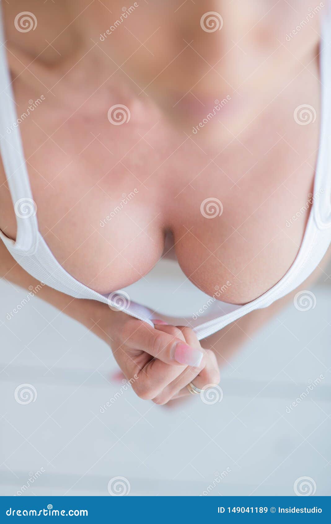 Woman Seductively Pulls Off a White Top Hands Exposing a Big Breast.  Beautiful Elastic Breasts Perfect Shape Stock Image - Image of erotic,  implants: 149041189