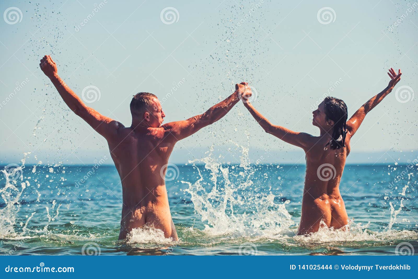 Appealing naked babes are relaxing on the beach