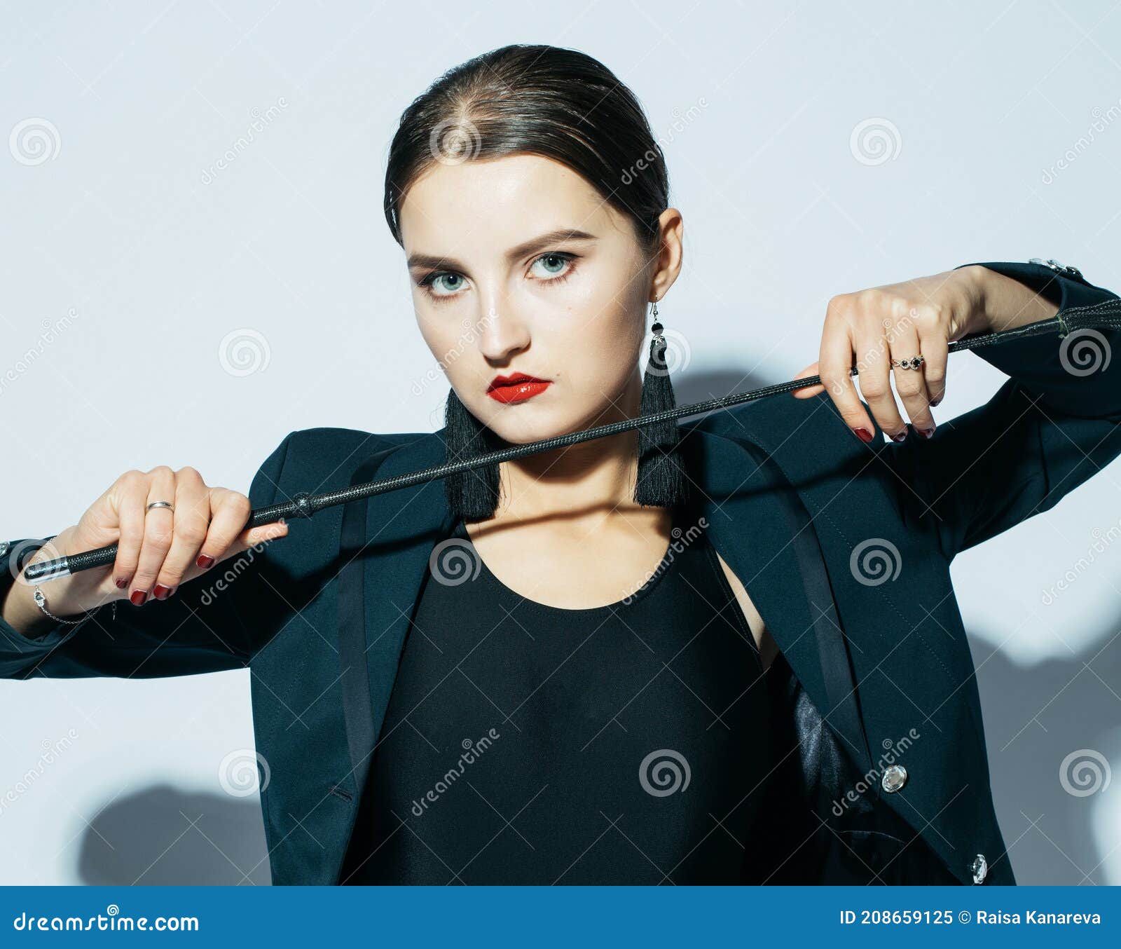 Cropped View Of Seductive Woman Holding Flogging Whip In Mouth Isolated On  Black Stock Photo, Picture and Royalty Free Image. Image 141254496.