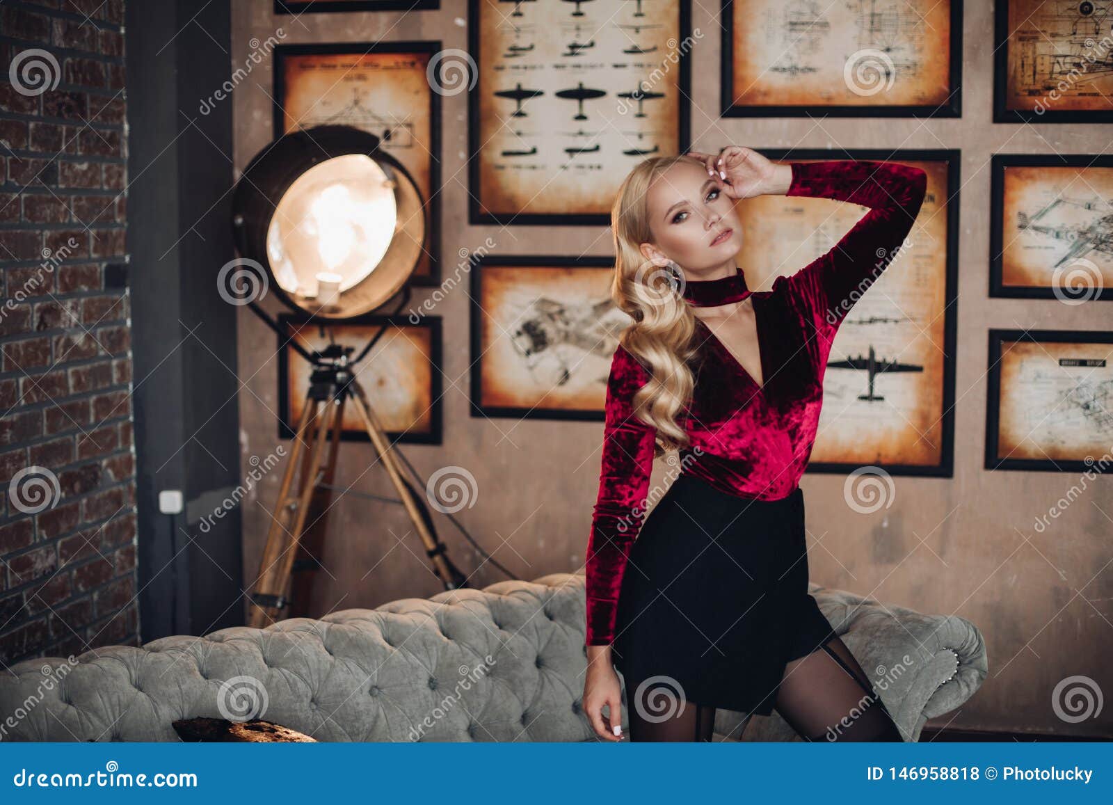 Sexy Young Blonde Woman In Stylish Evening Dress And Tights At Sofa ...