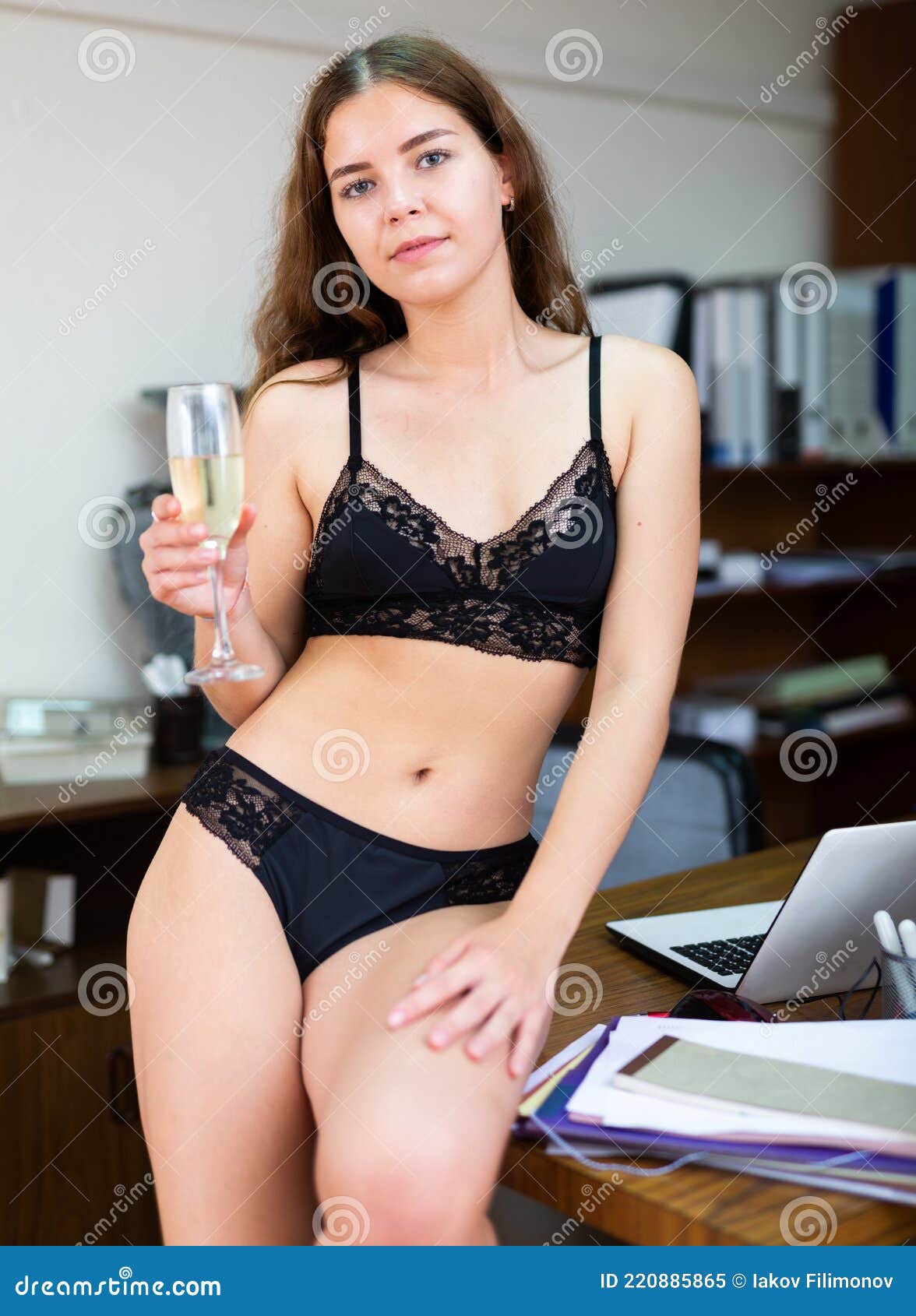Young Businesswoman in Bra and Panties Posing with Office Stock