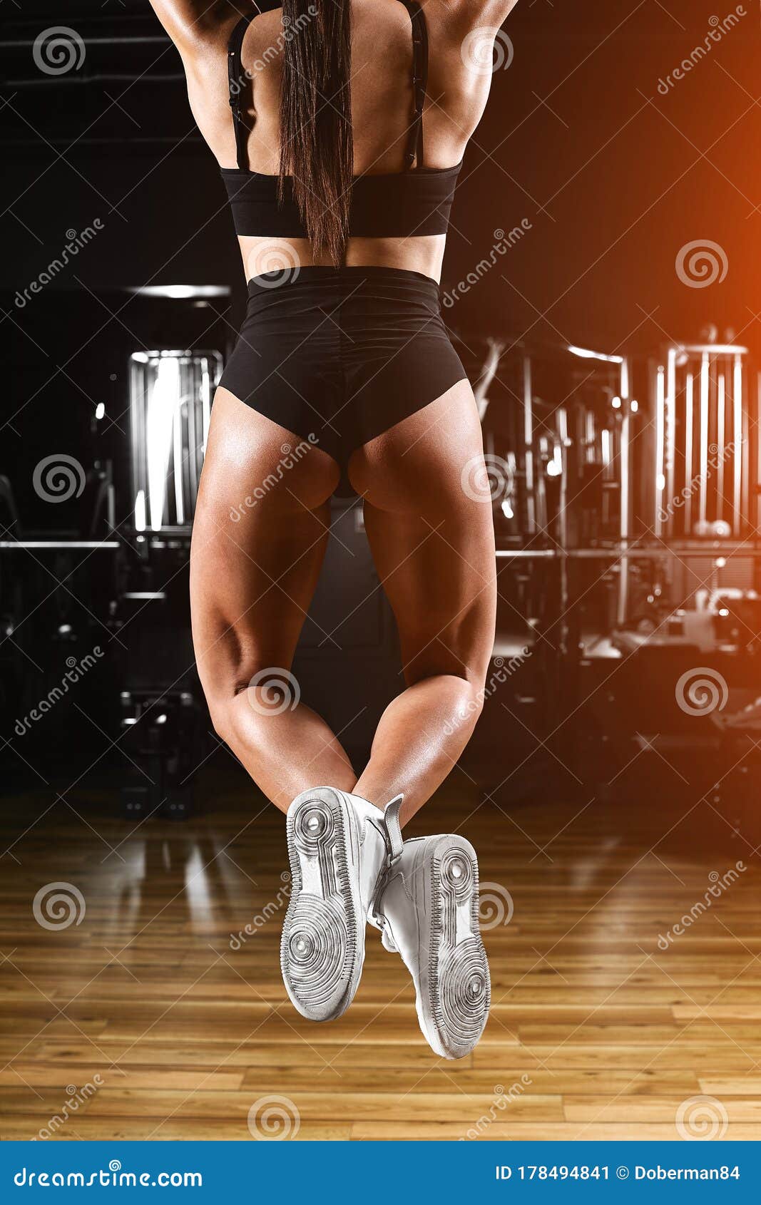 Sexy athletic girl working out in gym. Fitness woman doing exercise, sports  concept фотография Stock