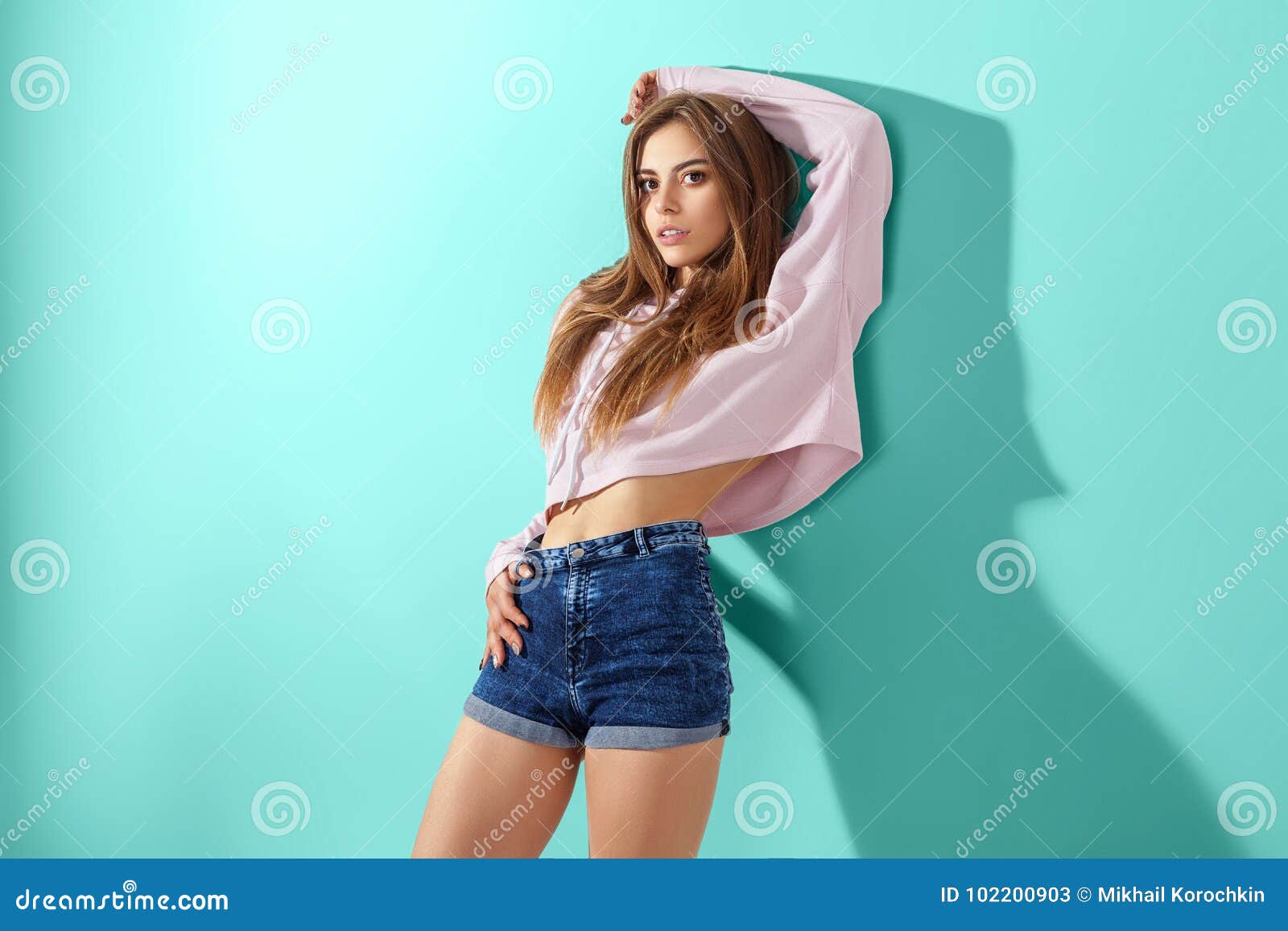 Young Girl on Blue Background Stock Image - Image of jeans, attractive ...