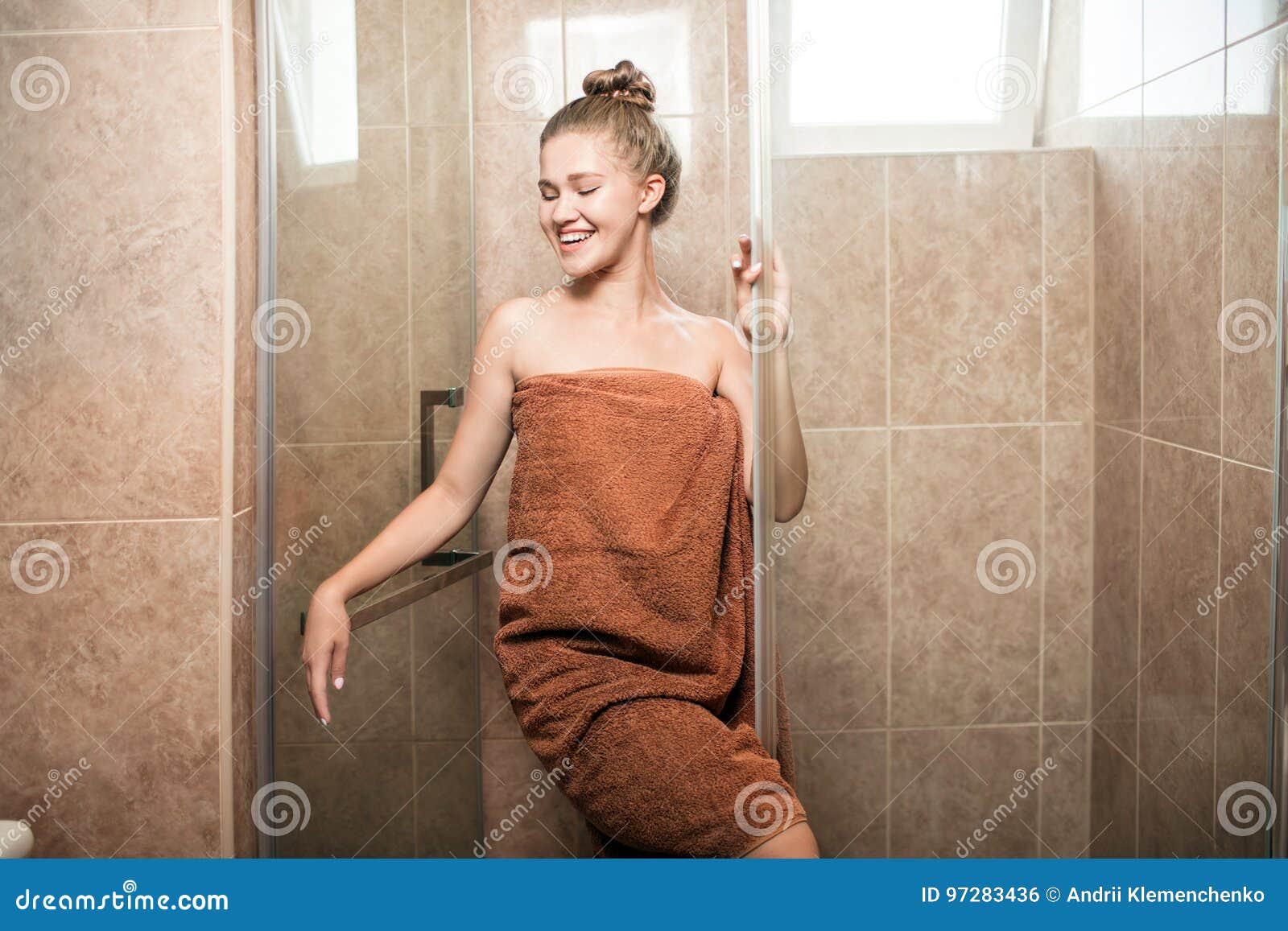 A Sexy Young Girl Takes A Shower In The Bathroom On A Brown Tile Background The Attractive 