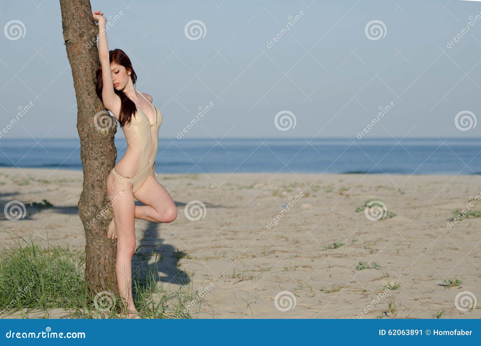 young red hair woman wearing coverall bikini